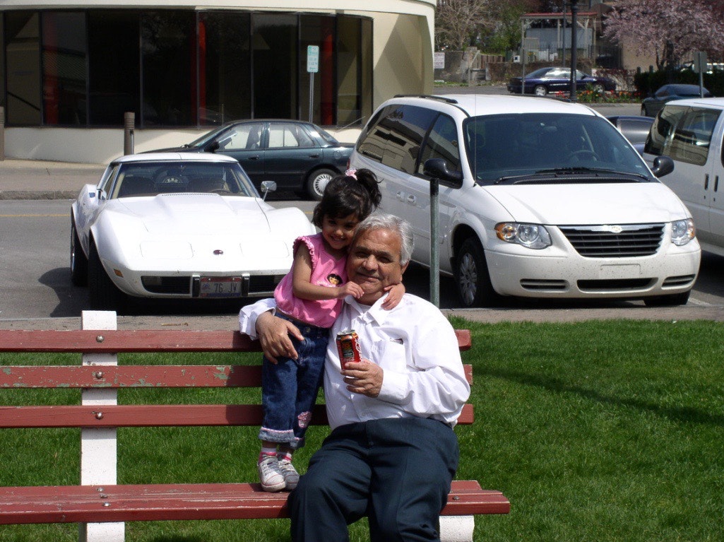 My daughter and my father sitting on a bench.