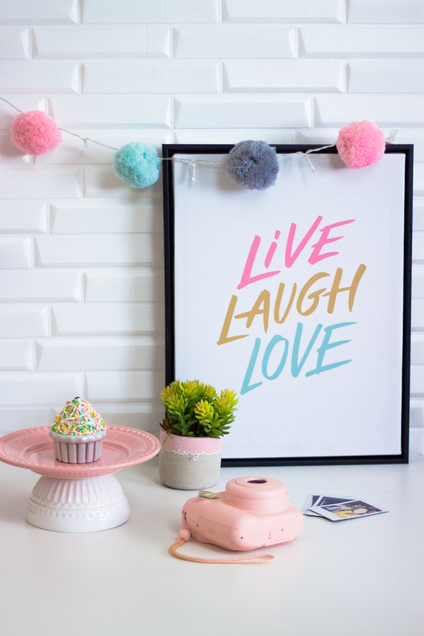 Pink decorations which say live laugh love